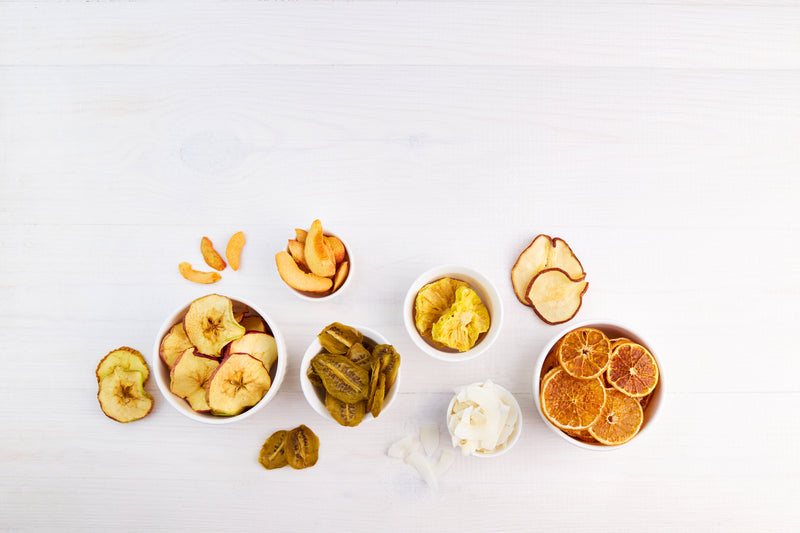 six bowls of different dried fruit on a table